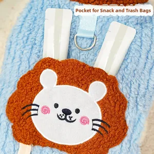Close-up of blue fleece pet vest with lion pocket and metal D-ring for leash