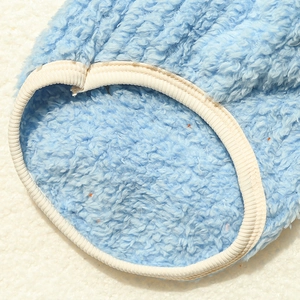 Close-up of sky blue sherpa fleece fabric with white ribbed edge on pet clothing