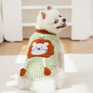 Detail of green fleece dog vest featuring a 3D lion design and metal D-ring attachment