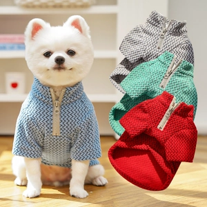 Detail of half-zip pet sweaters in herringbone knit featuring blue, grey, green, and red colors