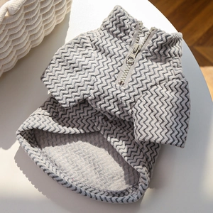 Close-up of pet sweater featuring gray zigzag knit texture and half-zip collar detail