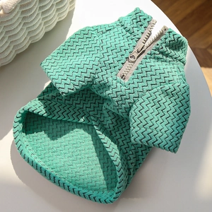 Detailed view of mint green pet vest with black V-wave texture and metal zipper
