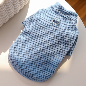 Close-up of blue textured knit pet vest with a sturdy silver metal D-ring for leashes