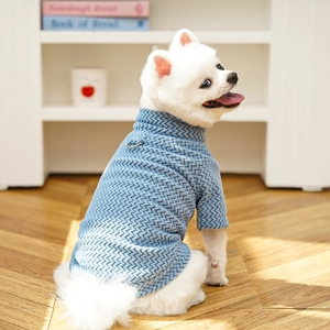 Close-up of light blue pet sweater featuring textured knit fabric and back D-ring hook
