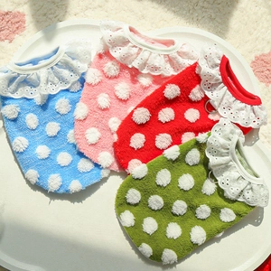 Detail of four colorful polka dot pet vests with lace collars and D-rings for dogs