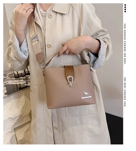Close-up of beige leather bucket bag featuring kangaroo logo and silver metal clasp detail