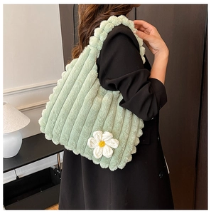 Light green faux fur tote bag featuring vertical stripes and white knit flower detail