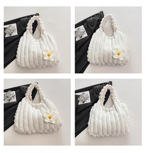 Detail view of white plush tote bag featuring vertical striped texture and daisy flower decor