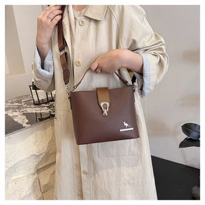 Detail of dark brown bucket bag featuring fine pebble leather and silver hardware accents