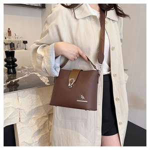 Detail of brown litchi pattern bucket bag with silver kangaroo logo and metal clasp