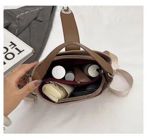 Interior view of spacious bucket bag showing compartments with phone and umbrella