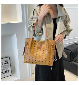Detail of shoulder tote bag with bear monogram pattern and faux leather fashion tag