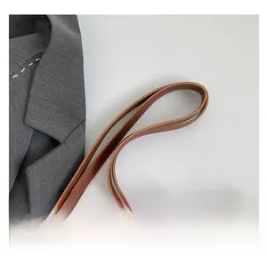 Close-up of vintage brown Visetos print tote bag with golden metal hardware detail