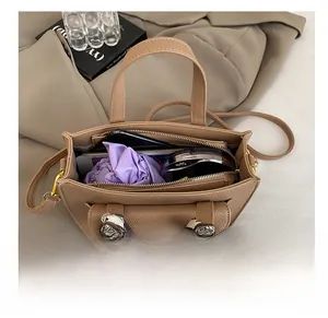 Spacious interior of a khaki lychee leather tote bag with silk scarf and daily essentials