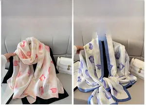 Detail of elegant floral silk scarves featuring pink and blue watercolor tulip patterns