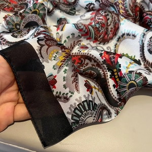 Lightweight faux silk scarf featuring ethnic Paisley prints and black satin borders