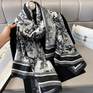 Luxurious 100% silk scarf with black and white jungle pattern hanging for display