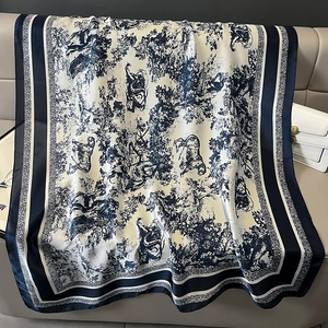 Detailed view of silk-like shawl featuring French toile de jouy pattern and wild animals