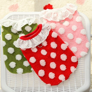 Close-up of dotted fleece dog vests with lace collar and metal D-ring attachment