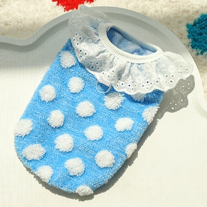 Close-up of blue pet vest featuring white plush polka dots and delicate lace collar