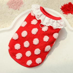 Close-up of red fleece dog vest with pink polka dots and white lace collar detail