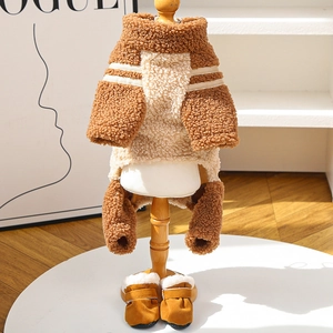 Detailed view of striped fleece dog sweater and matching snow boots on a wooden hanger