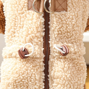Detail of warm sherpa pet coat featuring a secure brown zipper and metal D-ring for leash