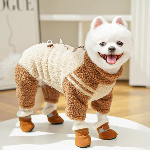 Close-up of beige fleece dog jumpsuit with striped cuffs and brown reflective boots