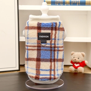 Detail of warm plaid pet vest with metal D-ring buckle and Fashion label on plush fabric