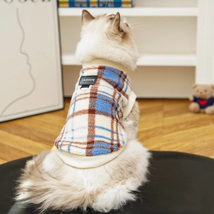 Detail of warm checkered pet vest with metal D-ring and fashion patch on a cat back