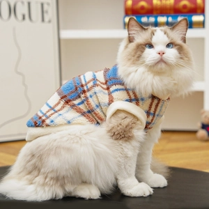 Close-up of plush plaid pet vest with soft fleece lining on a Ragdoll cat