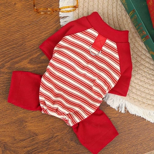 Detail of red and white striped dog jumpsuit with integrated metal D-ring for leash