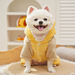 Close-up of soft yellow and brown coral fleece pet jumpsuit with white button details
