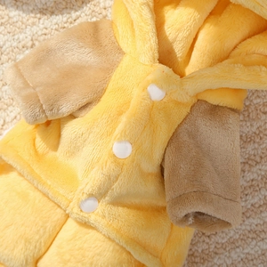 Detail of soft fleece pet jumpsuit with bright yellow flannel and white snap buttons