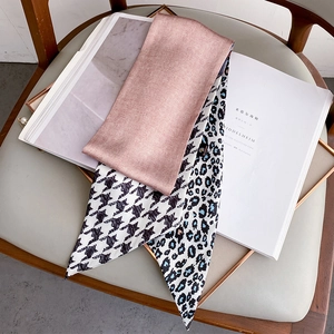 Detail of multi-pattern silk scarf featuring houndstooth and leopard print textures