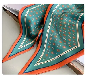Gros plan d'un foulard en soie à fleurs avec coutures intérieures soignées et imprimé vert