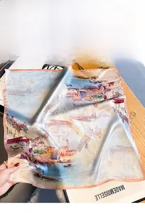 Détail d'un carré de soie avec imprimé peinture à l'huile sur table en bois