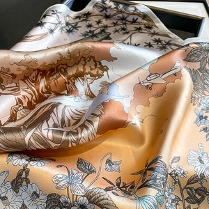 Silk scarf with vintage jungle and floral prints showing luxurious smooth texture and drape