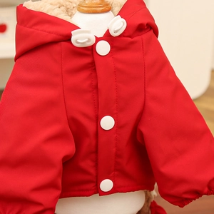 Close-up of waterproof red dog coat with white lamb wool lining and large buttons