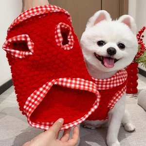 Detail of red fleece pet vest with festive red and white plaid trim for small dogs