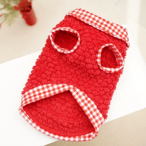 Close-up of red fleece pet vest with plaid trim and soft thermal fabric texture