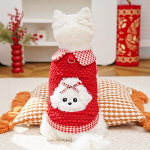 Detail of red fleece pet vest with dog embroidery and metal D-ring for leash attachment