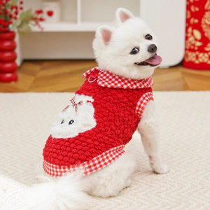 Detail of red fleece dog vest with plush rabbit motif and metal D-ring for leash