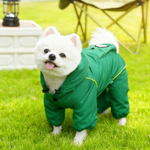 Detail of waterproof green dog raincoat with hood and reflective yellow striped trim