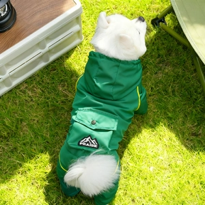 Detail of waterproof green dog raincoat with embroidered patch and functional pocket