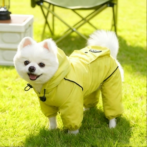 Detail of waterproof dog raincoat with adjustable drawstring and back pocket on grass