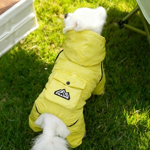 Detailed view of the yellow waterproof dog jumpsuit with Praise mountain logo pocket