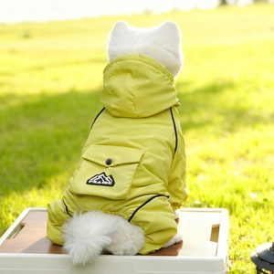 Close-up of waterproof dog raincoat with hood and PRAISE pocket on neon yellow fabric
