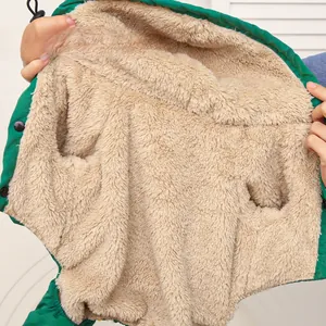 Detailed close-up of the thick faux lamb fleece lining on a green winter dog jacket