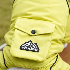 Detail of waterproof dog jacket with neon yellow fabric, functional pocket and logo patch